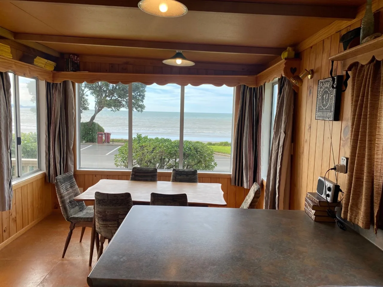 Bach A kitchen bench and dining table overlooking the sea