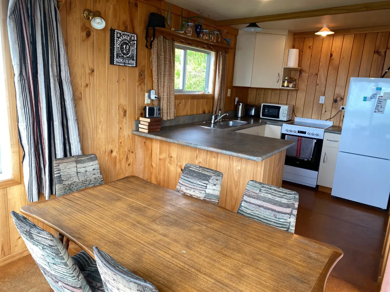 Timber kitchen cupboards and dining area in Bach A